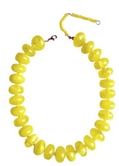Yellow beaded necklace on a white background