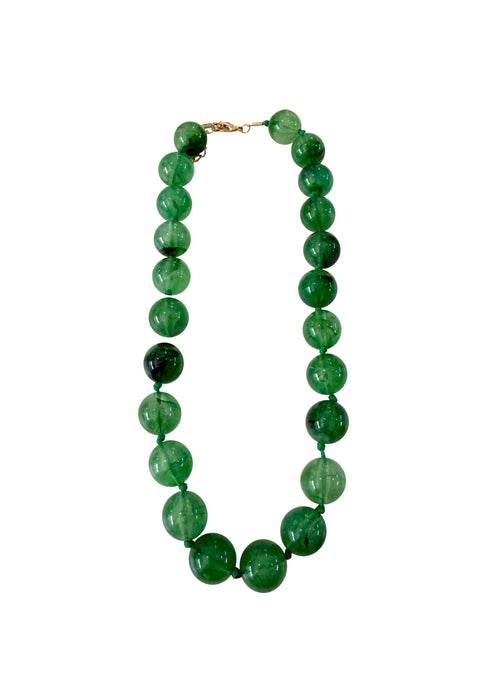 Green beaded necklace on a white background