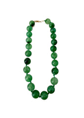 Green beaded necklace on a white background
