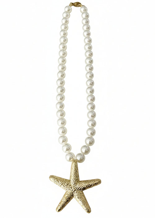 Pearl necklace with a gold starfish pendant on a white background