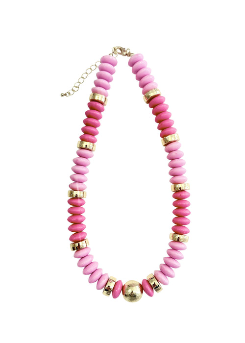 Necklace with pink beads and gold accents on a white background