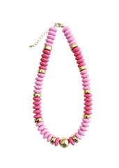 Necklace with pink beads and gold accents on a white background