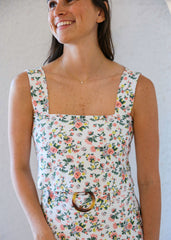 Woman wearing a floral dress with a plain background