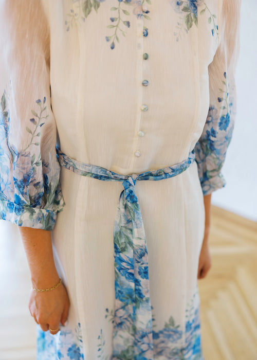 Woman wearing a floral dress with a white background