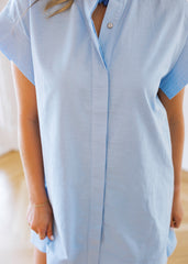 Light blue shirt worn by a person with a blurred background