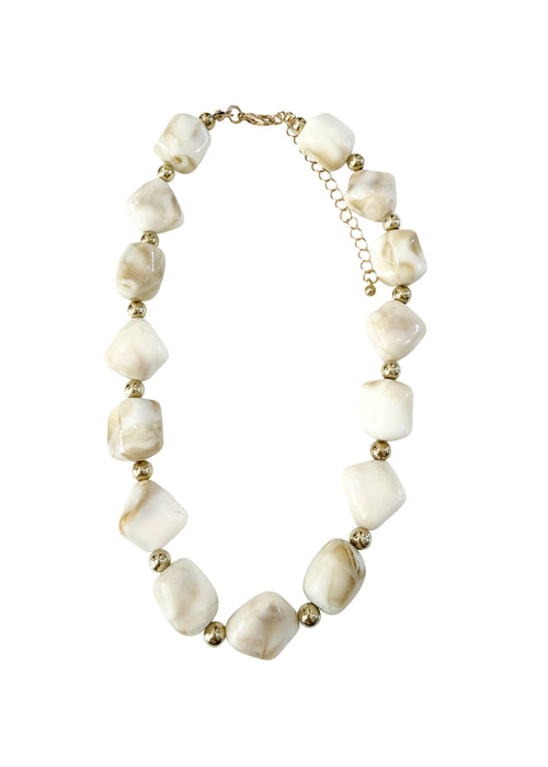 Necklace with white beads and gold accents on a white background