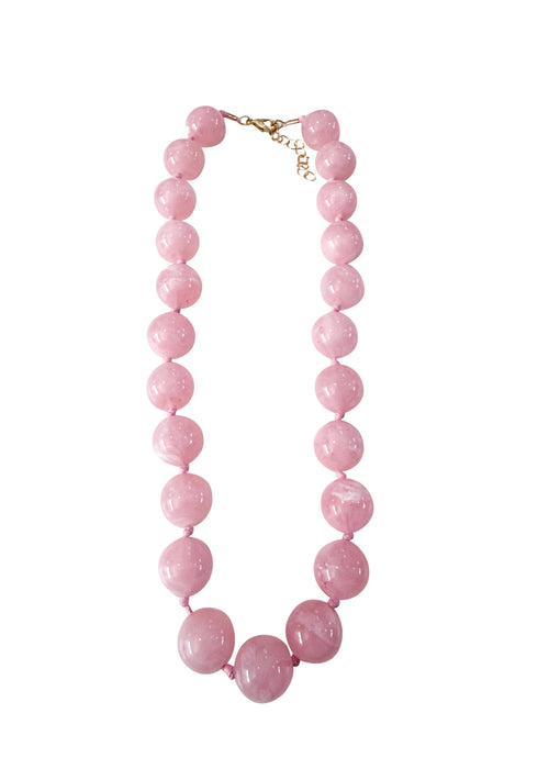 Pink beaded necklace on a white background
