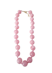 Pink beaded necklace on a white background