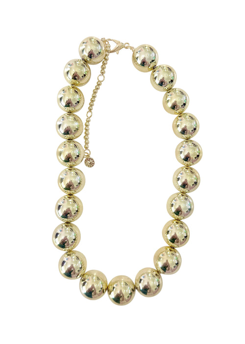 Gold beaded necklace on a white background