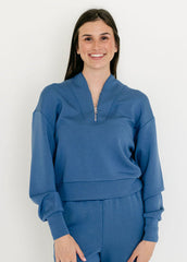 Woman wearing a blue outfit against a white background