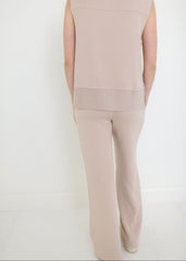 Beige sleeveless top and pants set on a white background