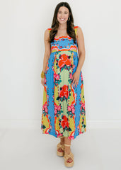 Woman wearing a colorful floral dress on a white background
