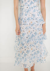 Woman wearing a floral dress with a white background