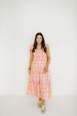 Woman wearing a plaid dress on a white background