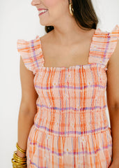 Woman wearing a colorful dress with a white background