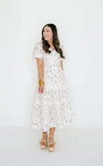 Woman wearing a white floral dress on a white background