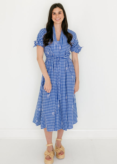 Woman wearing a blue checkered dress on a white background