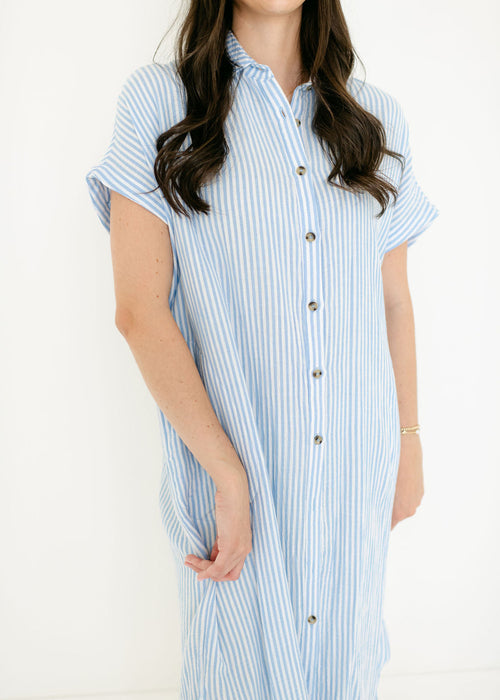 Woman wearing a blue and white striped dress on a white background
