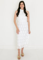 Woman wearing a white lace dress against a white background
