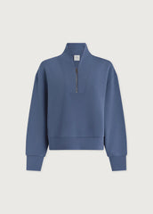 Blue sweatshirt with a quarter zip on a light gray background