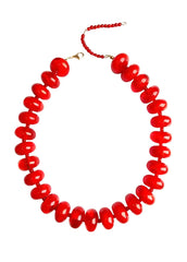 Red beaded necklace on a white background