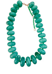Green beaded necklace on a white background